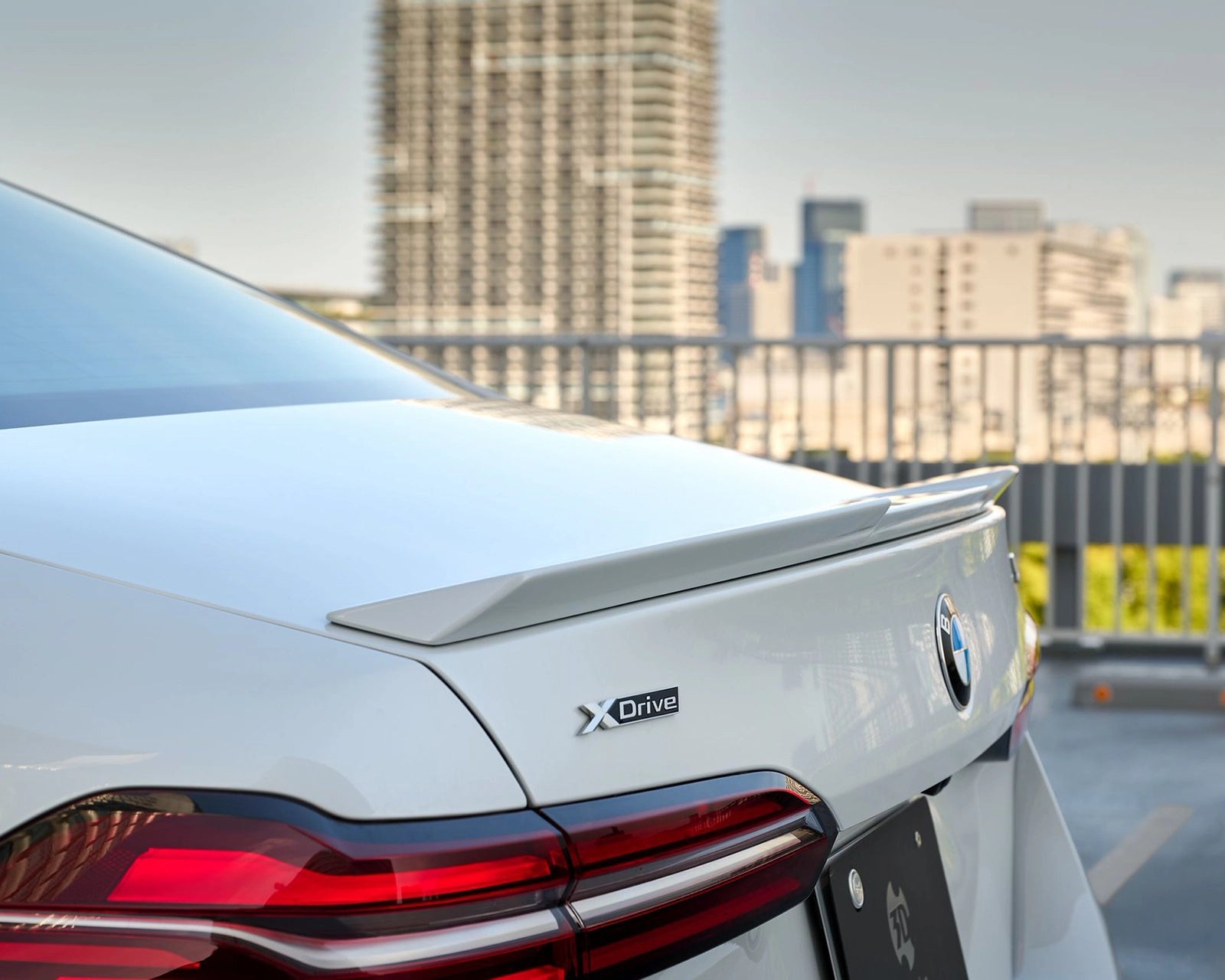3DDesign GFRP trunk spoiler for BMW G60 and G90 M5, side detail on a white BMW 5 Series