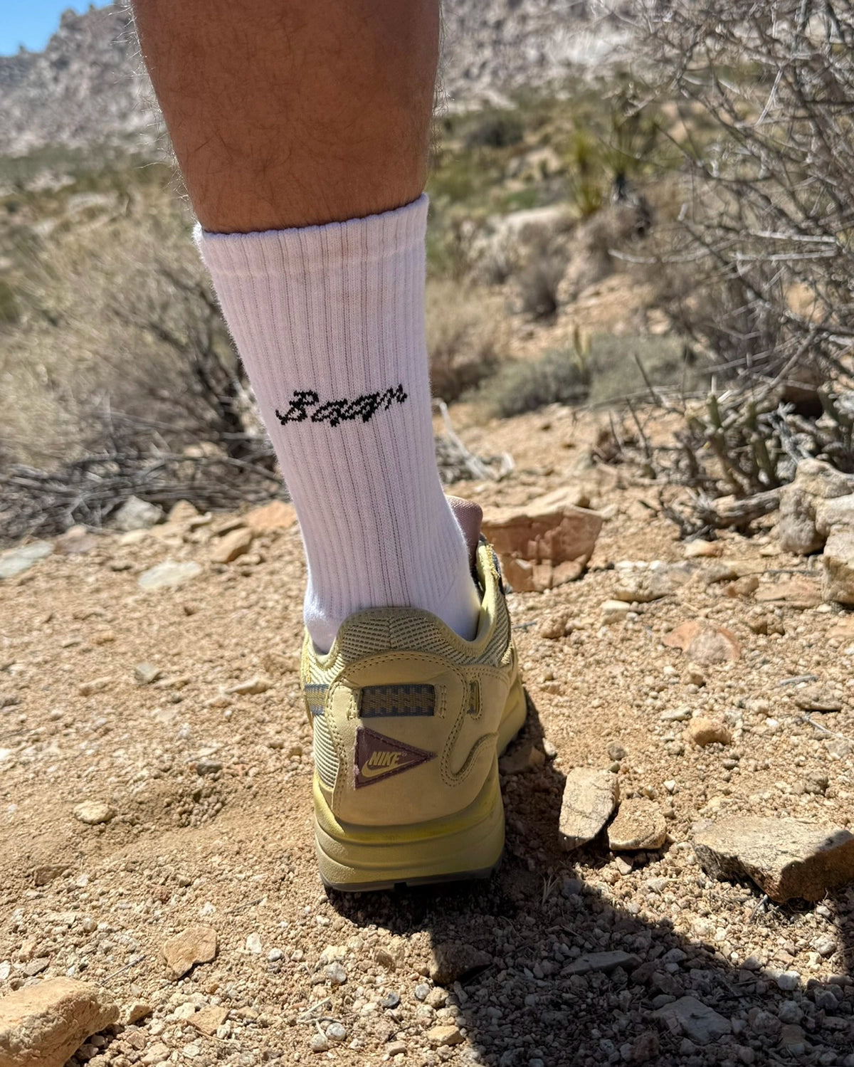 baan white crew socks on foot in the desert