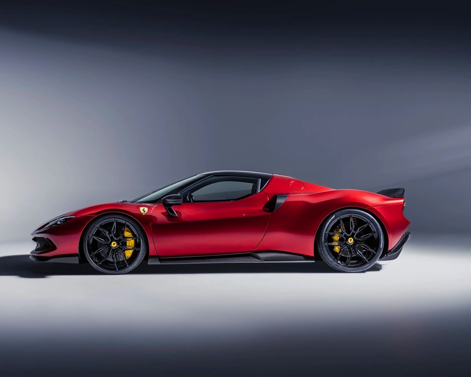 Ferrari 296 side profile driving on open road showing side air inlets