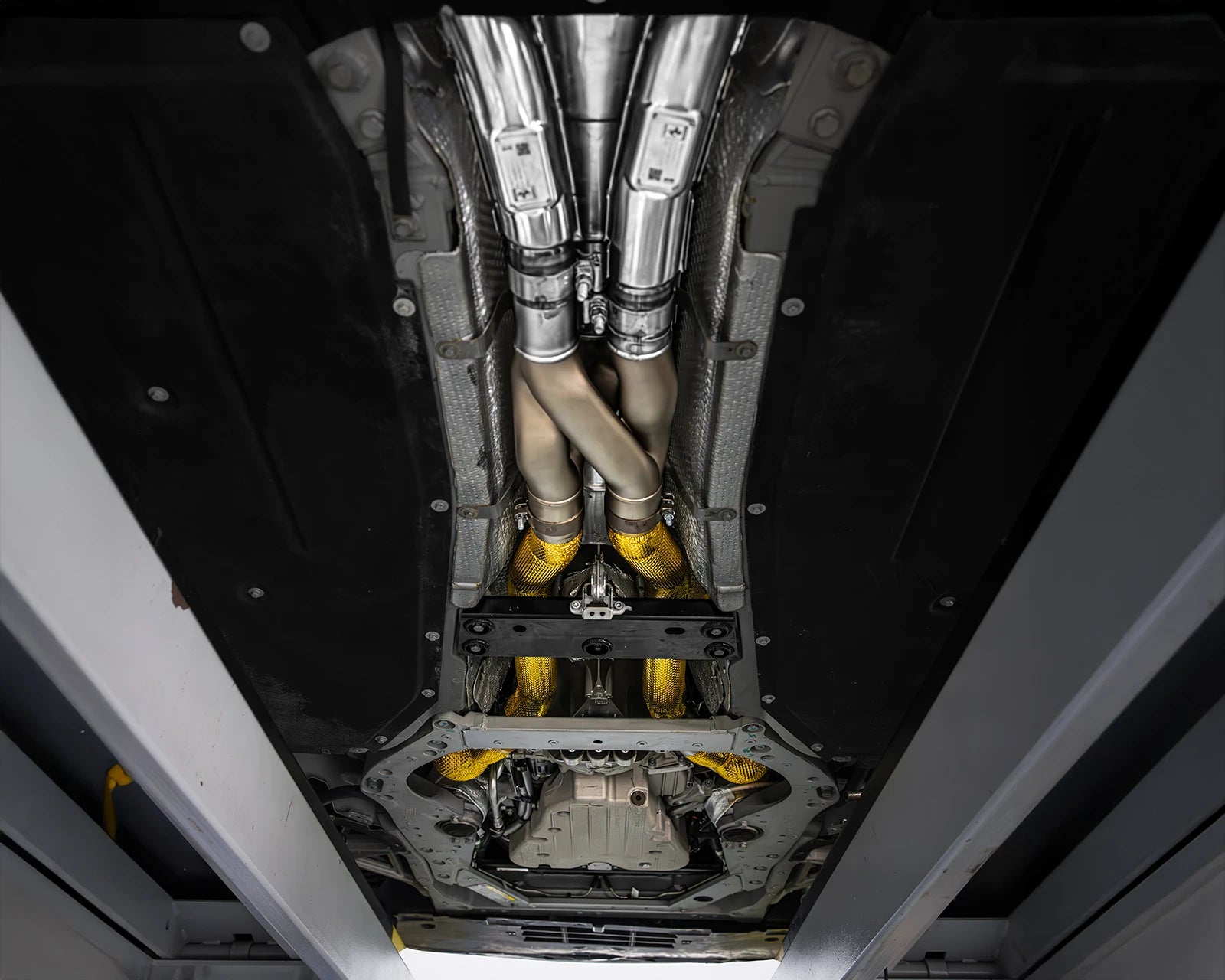 IPE downpipes and Z-pipe midpipe installed on Ferrari Roma – undercar view