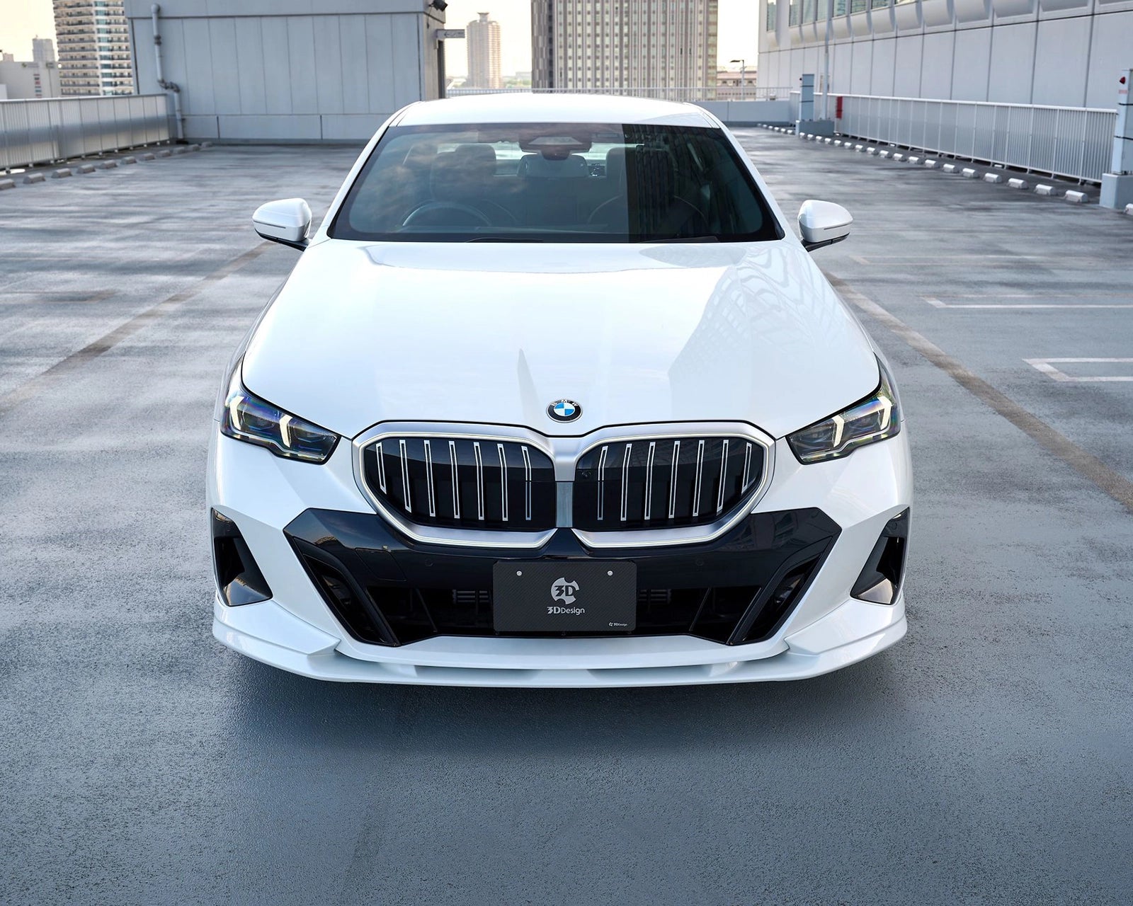 Front view of a white BMW G60 M Sport fitted with the 3DDesign urethane front lip spoiler