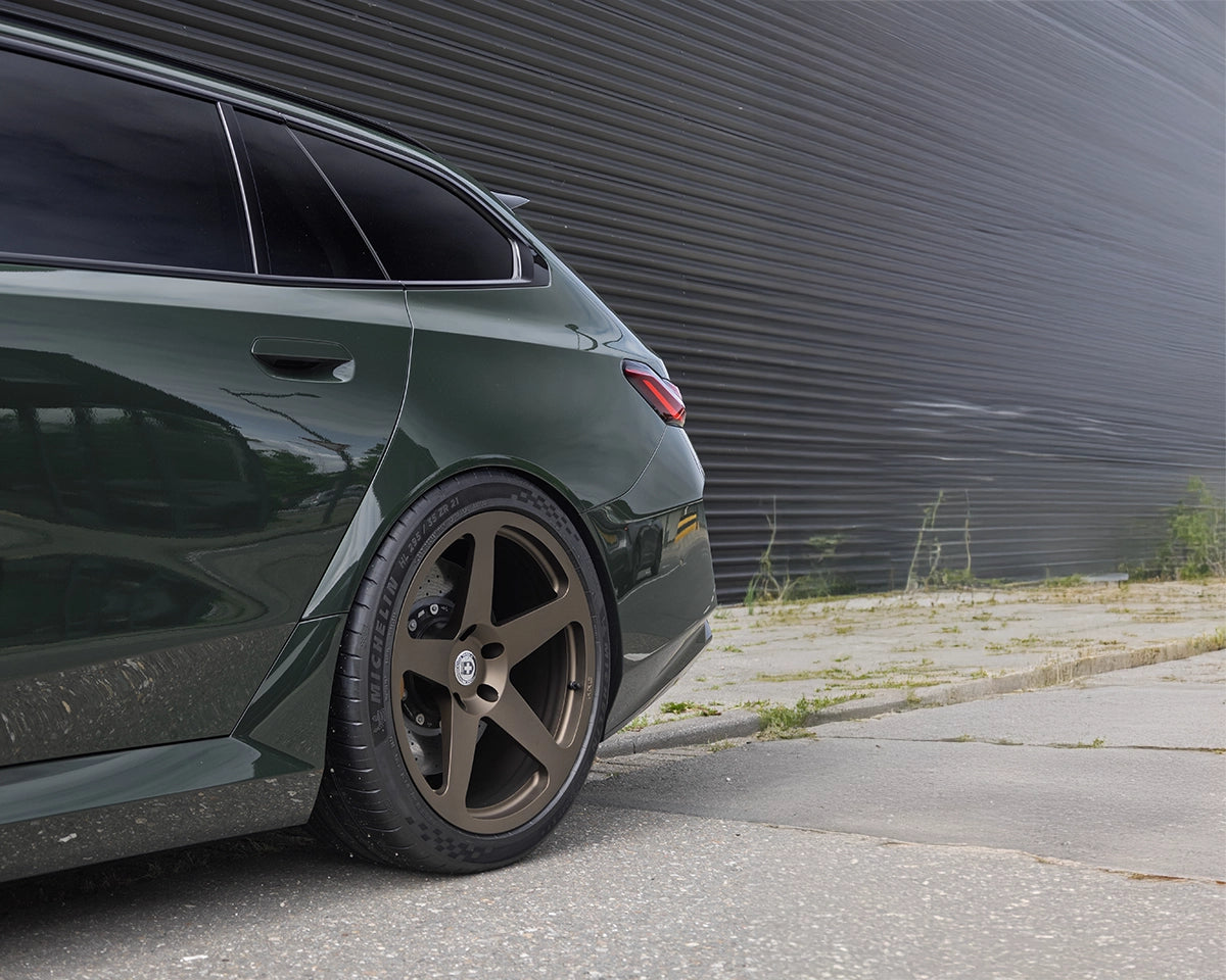 Green BMW G99 M5 Touring lowered with KW Height Adjustable Springs and fitted with HRE 305M wheels in Satin Bronze finish