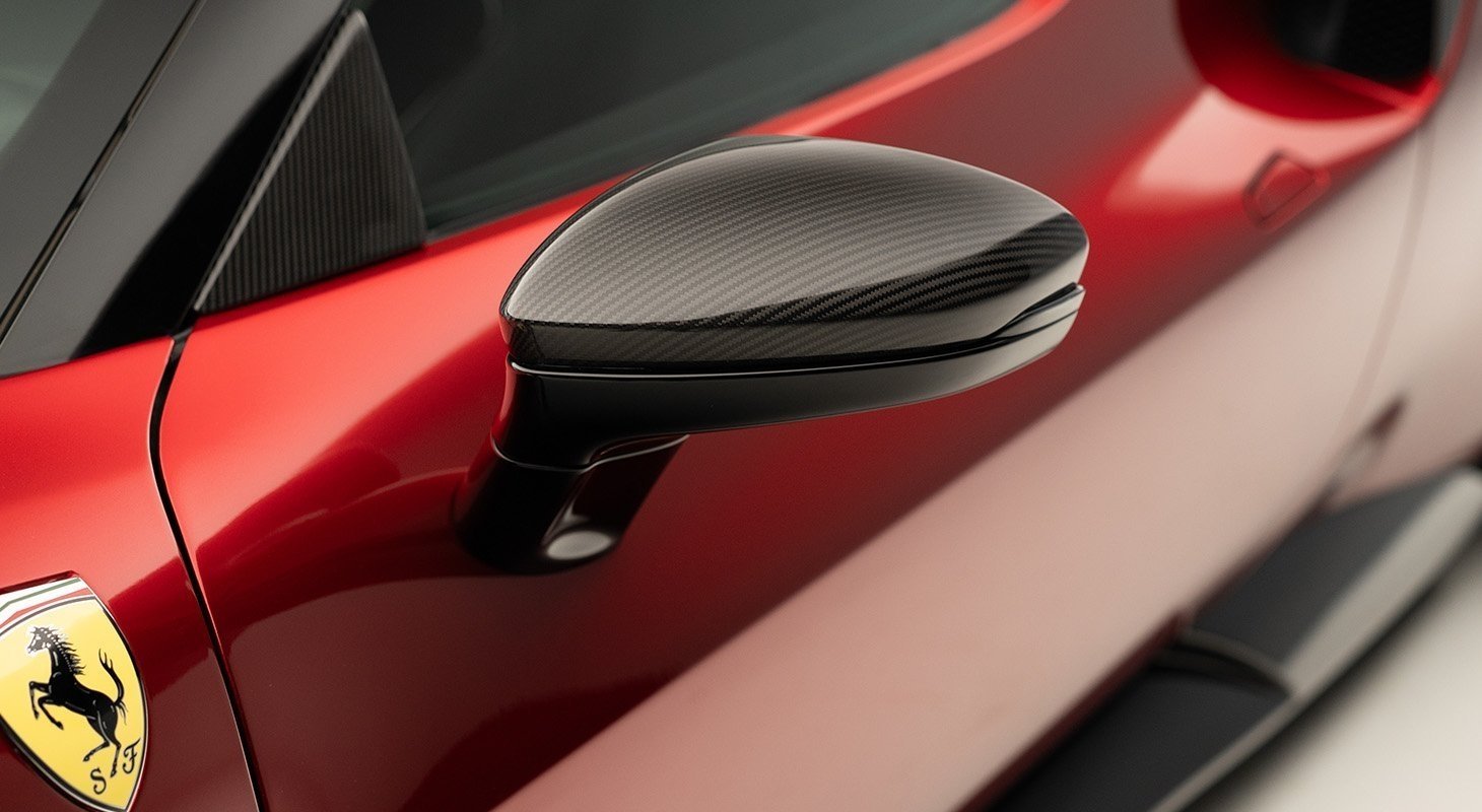 Close-up of Ferrari 296 carbon mirror caps by Novitec